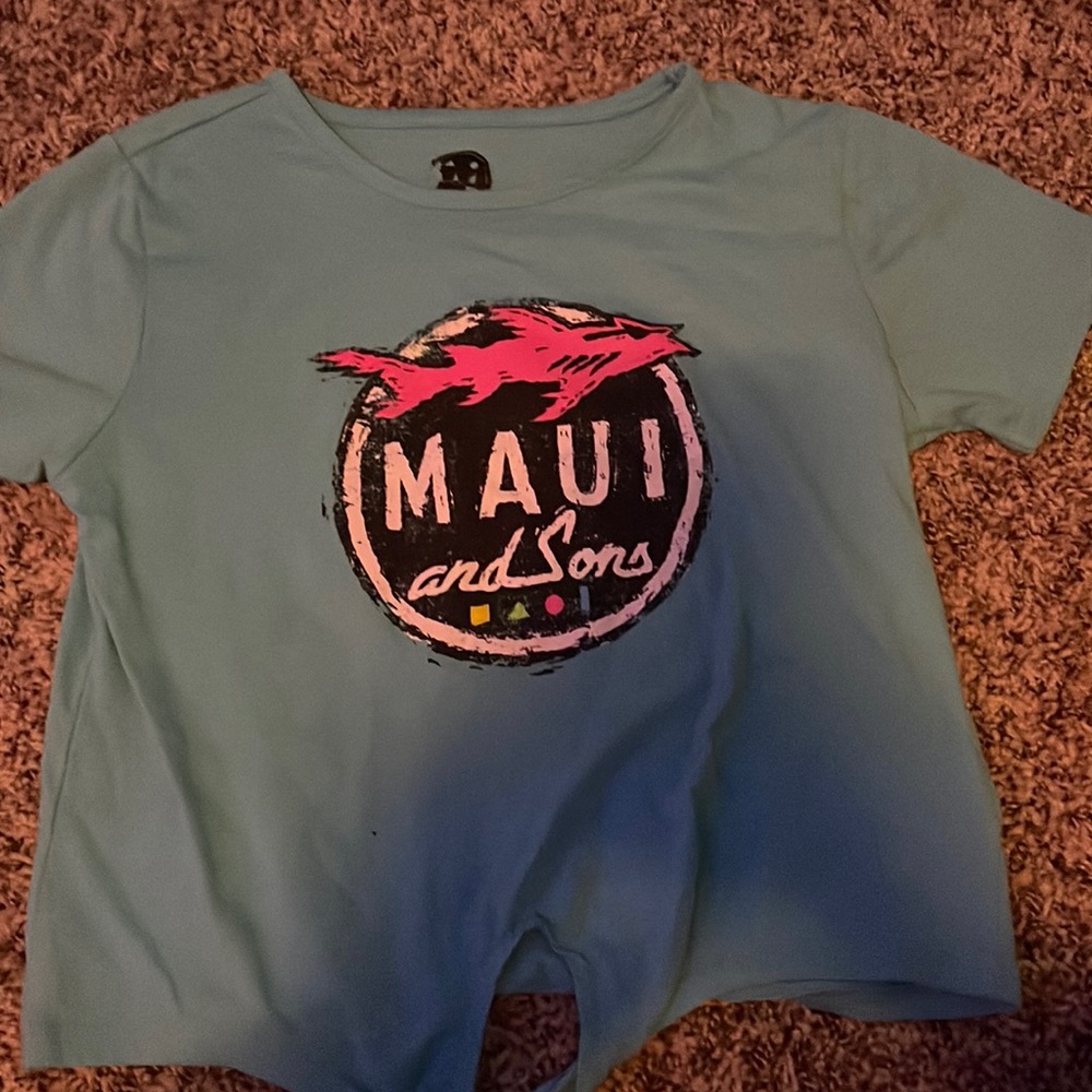 The color of the shirt is blue. It is in great quality,there are no stain on it